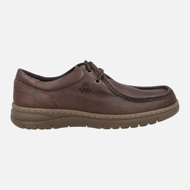 Men's Wallabee style laced shoes on brown leather