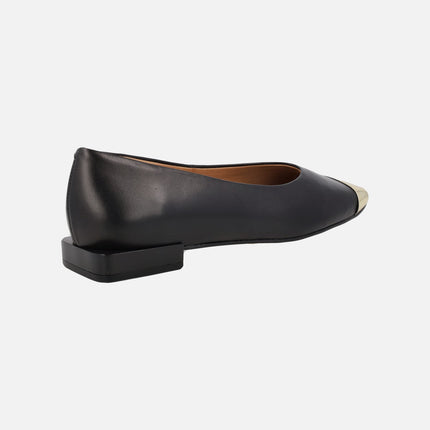 Black leather flats with golden metallic toe