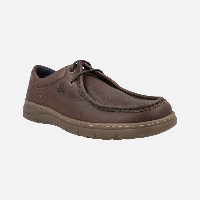 Men's Wallabee style laced shoes on brown leather