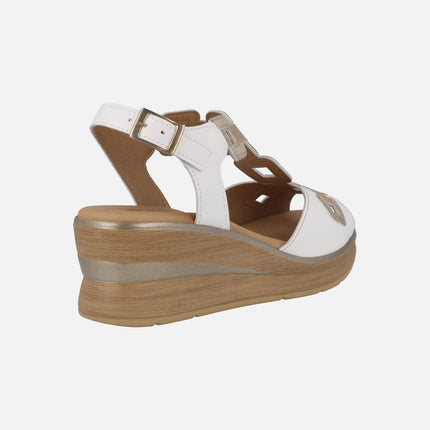Wedged sandals in white leather with golden details