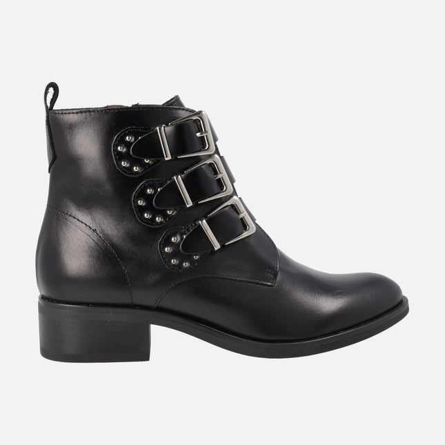 Black leather ankle boots with triple buckled strips and studs