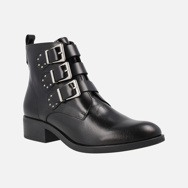 Black leather ankle boots with triple buckled strips and studs