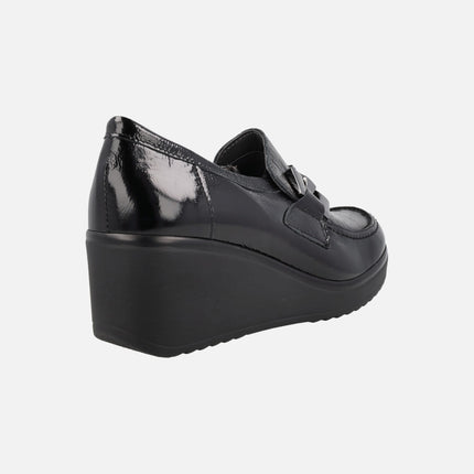 Black patent leather moccasins with high wedge and metallic ornament