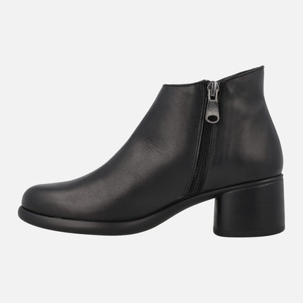 Black leather ankle boots with circular ornament and low heel