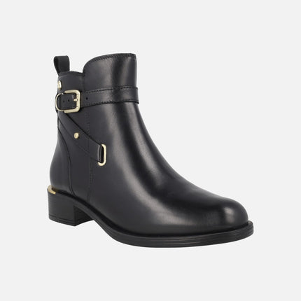 Black leather ankle boots with golden metal details