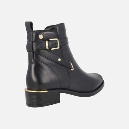 Black leather ankle boots with golden metal details
