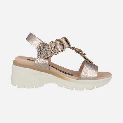 Golden leather sandals with buckle decoration and medium wedge