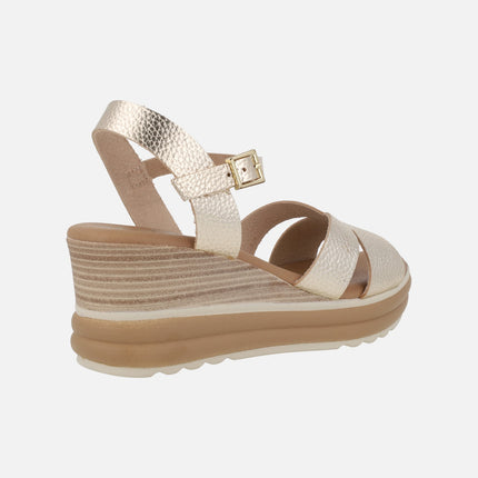 Wedge sandals in light gold metallic leather