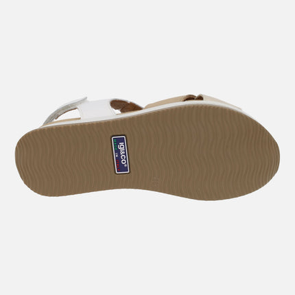 Beige and white crossed strap sandals with velcro closure