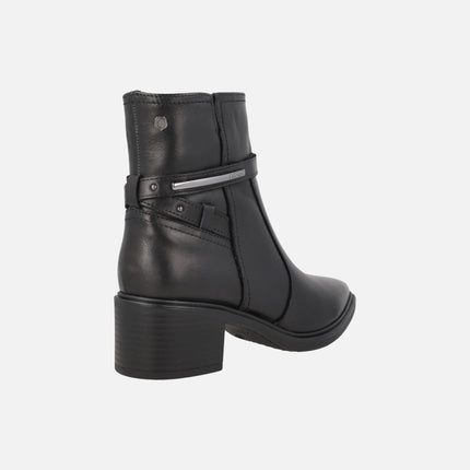 Women's high-heeled ankle boots in black leather with metallic decoration