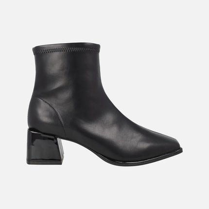 Black ankle boots in elastic leather-effect materials