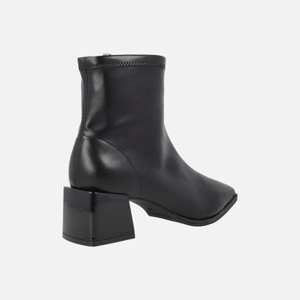 Black ankle boots in elastic leather-effect materials