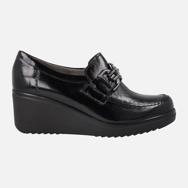 Black patent leather shoes with metallic decoration and wedge