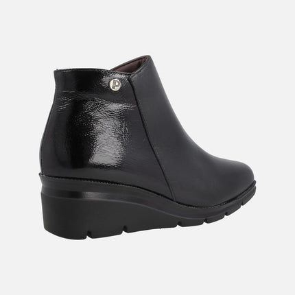 Black ankle boots in combined leather and patent leather with medium wedge