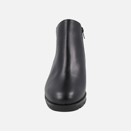 Black ankle boots in combined leather and patent leather with medium wedge