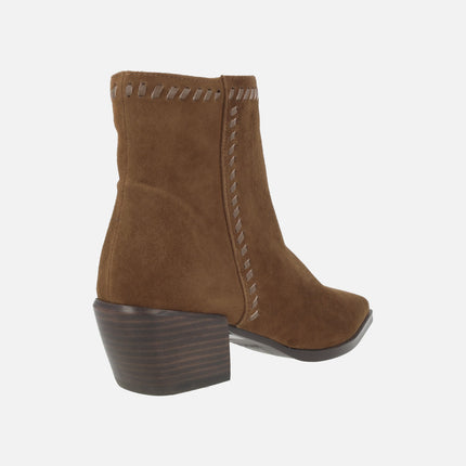Heeled ankle boots in suede leather with leather stitching