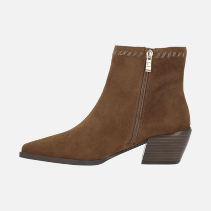 Heeled ankle boots in suede leather with leather stitching